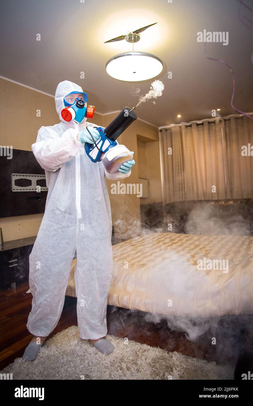 disinfection of the room against viruses. Man in quarantine clothes