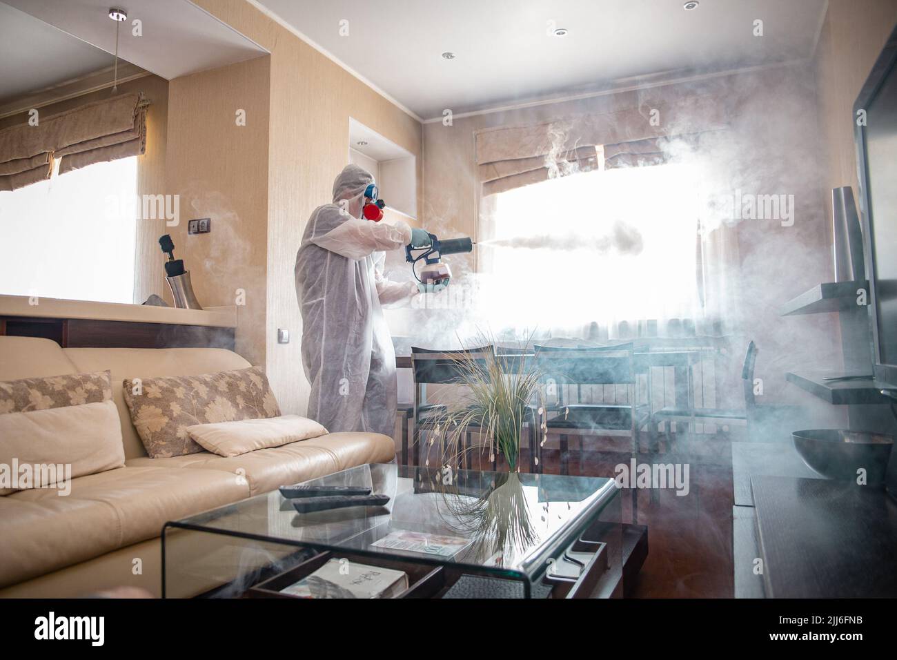 disinfection of the room against viruses. Man in quarantine clothes