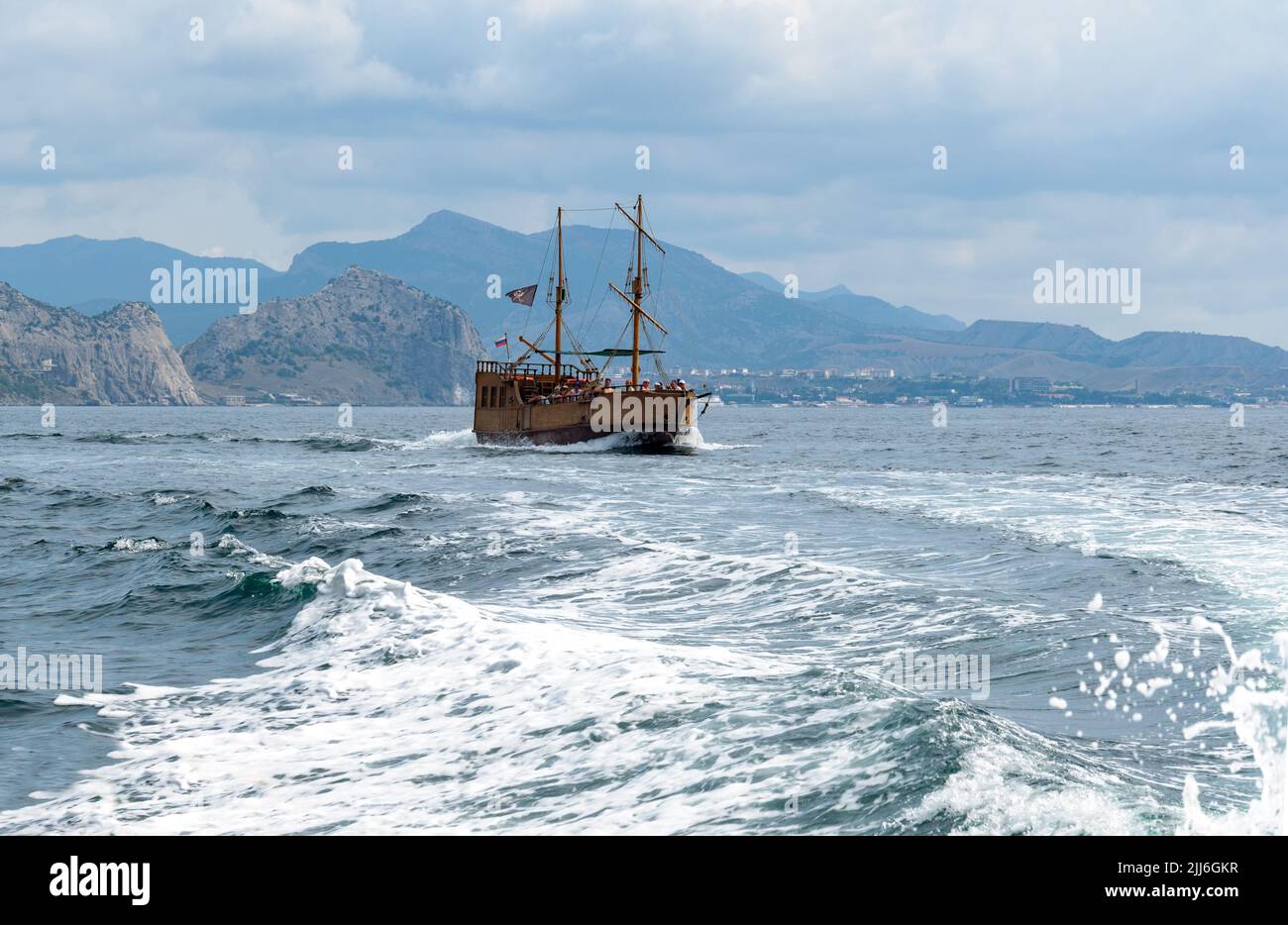 August 27, 2021 Republic of Crimea, suburbs of the city of Novy Svet, editorial. Tourists are sailing on a sailing ship on the Black Sea. In a picture Stock Photo