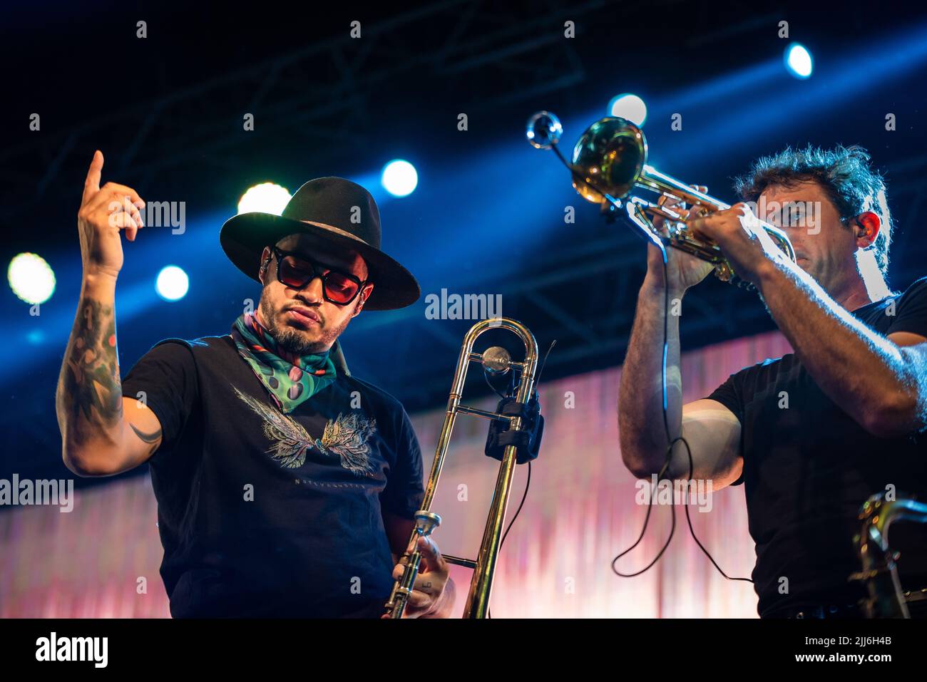 Denis Silveira waves the crowd while Martin Gil perform a trumpet solo during No Te Va a Gustar show in Corrientes, Argentina. Stock Photo