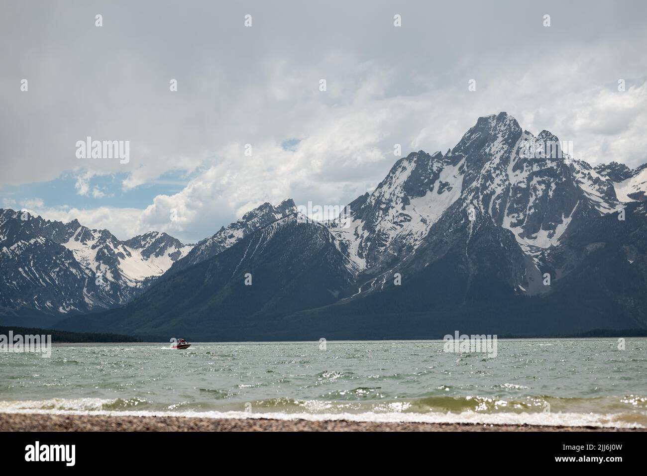 The Jackson Lake and a boat overlooked by the mountains Stock Photo Alamy