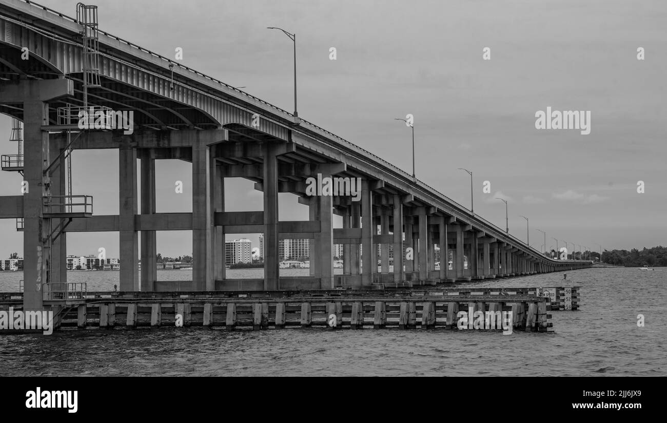 A grayscale shot of a stone bridge over water in Fort Mayer Stock Photo ...
