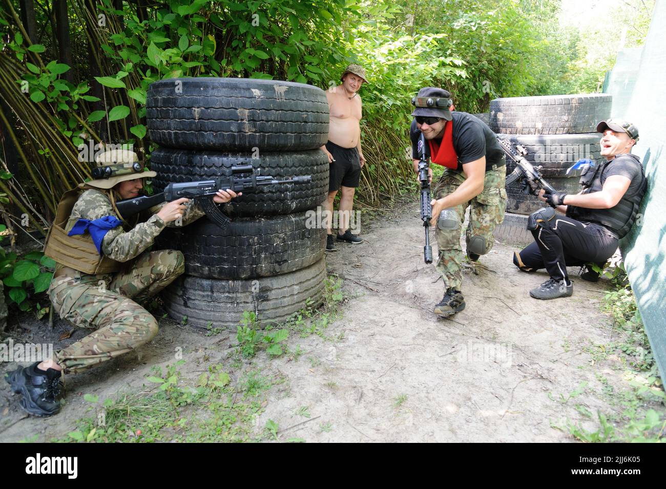 Ukrainian civilians using laser tag weapons take part in tactical
