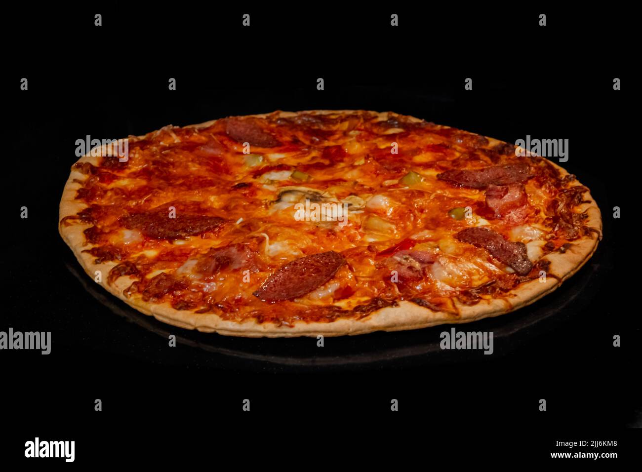 Burnt homemade pizza on tray in electric oven, black background Stock Photo Alamy