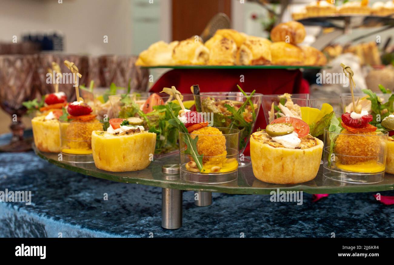 snacks and salads on the buffet table. catering at the event Stock