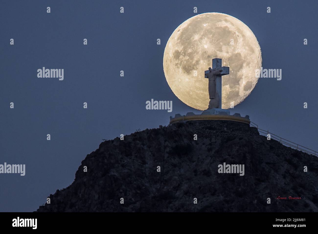 A beautiful shot of Mount Cristo Rey, with a large full moon in the