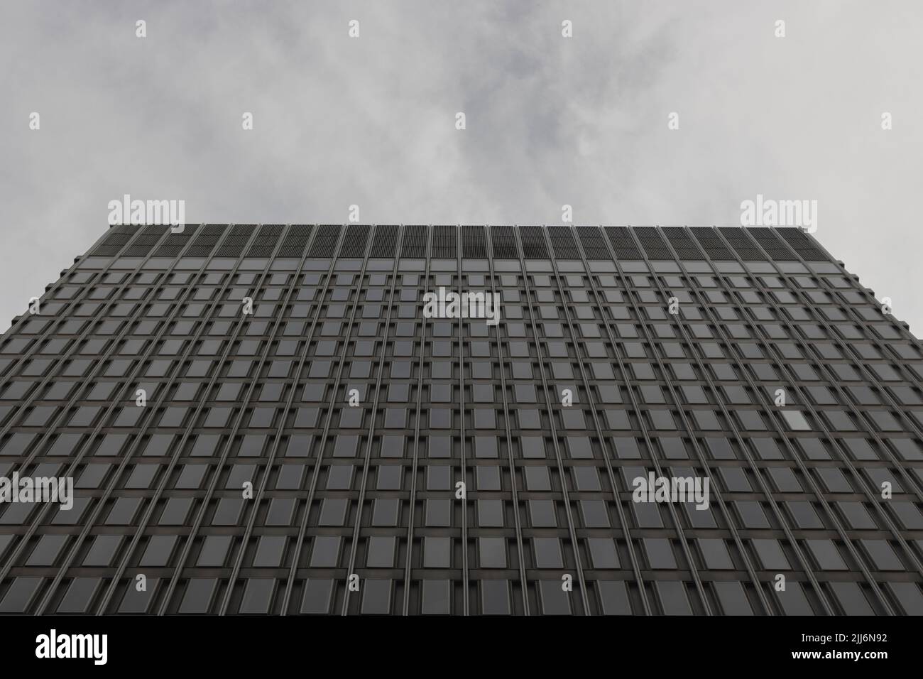 A low-angle grayscale shot of a modern glazed building Stock Photo - Alamy