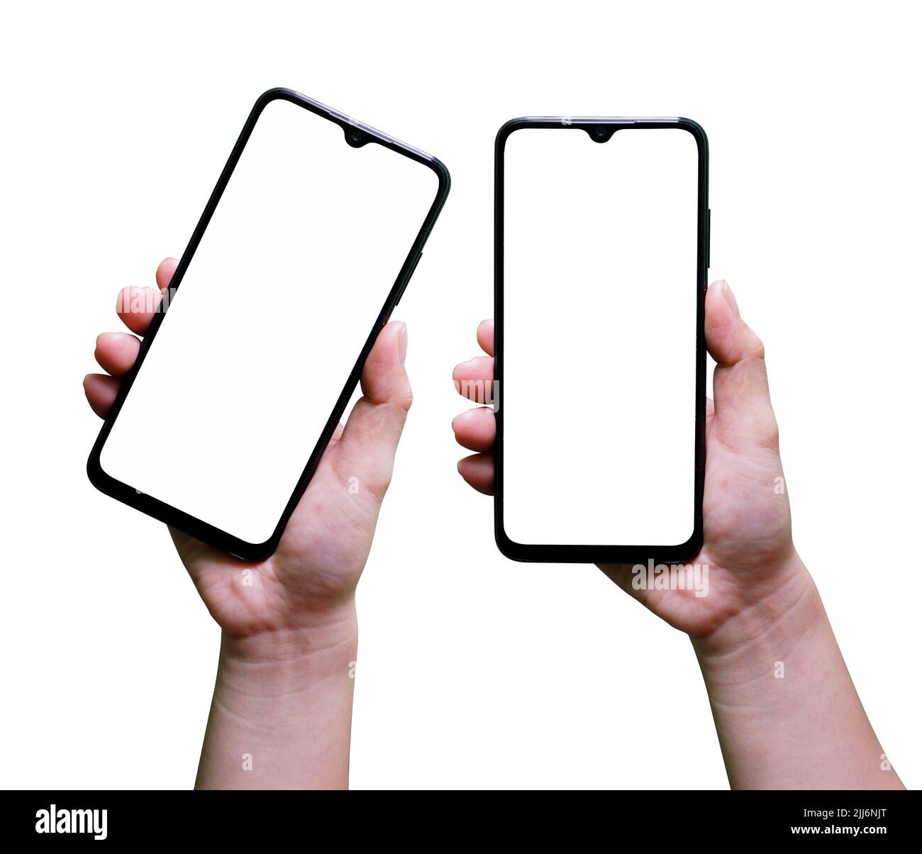A pair of hands holding smartphones with blank copy space screens on a ...