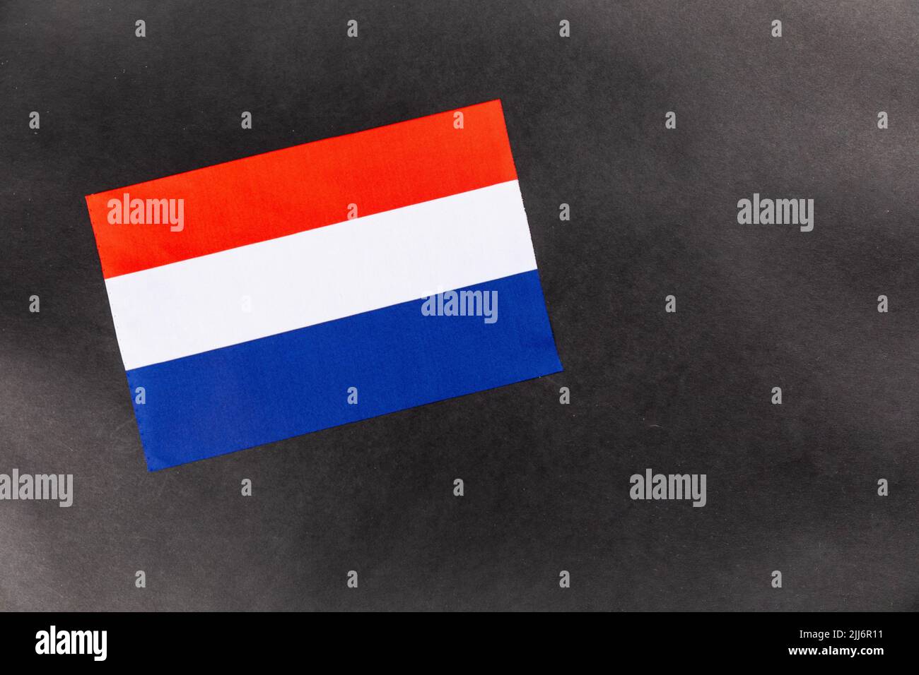 A close-up shot of the flag of Luxembourg on a dark background with copy space Stock Photo