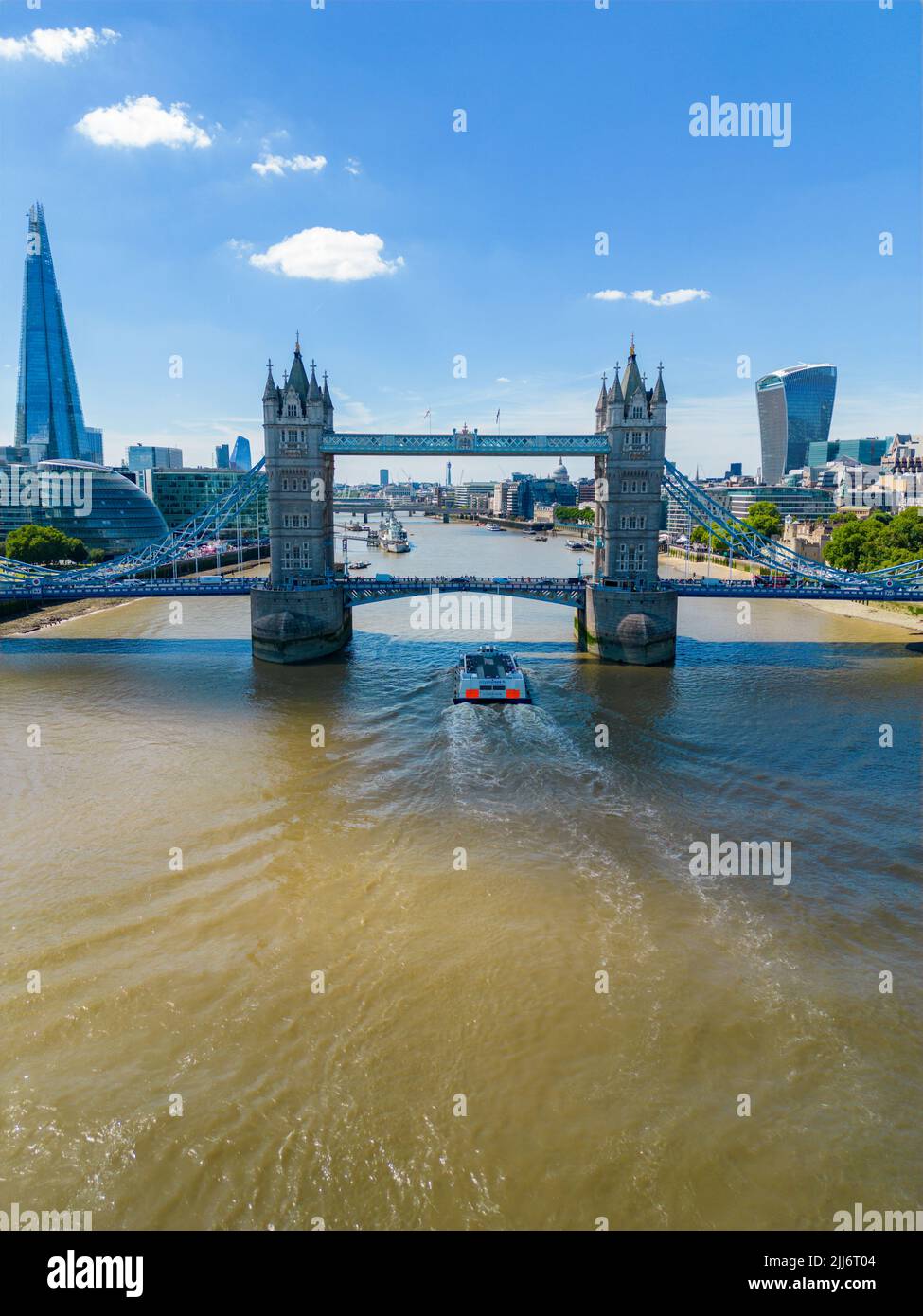Tower Bridge in London with tour boat passing under Stock Photo