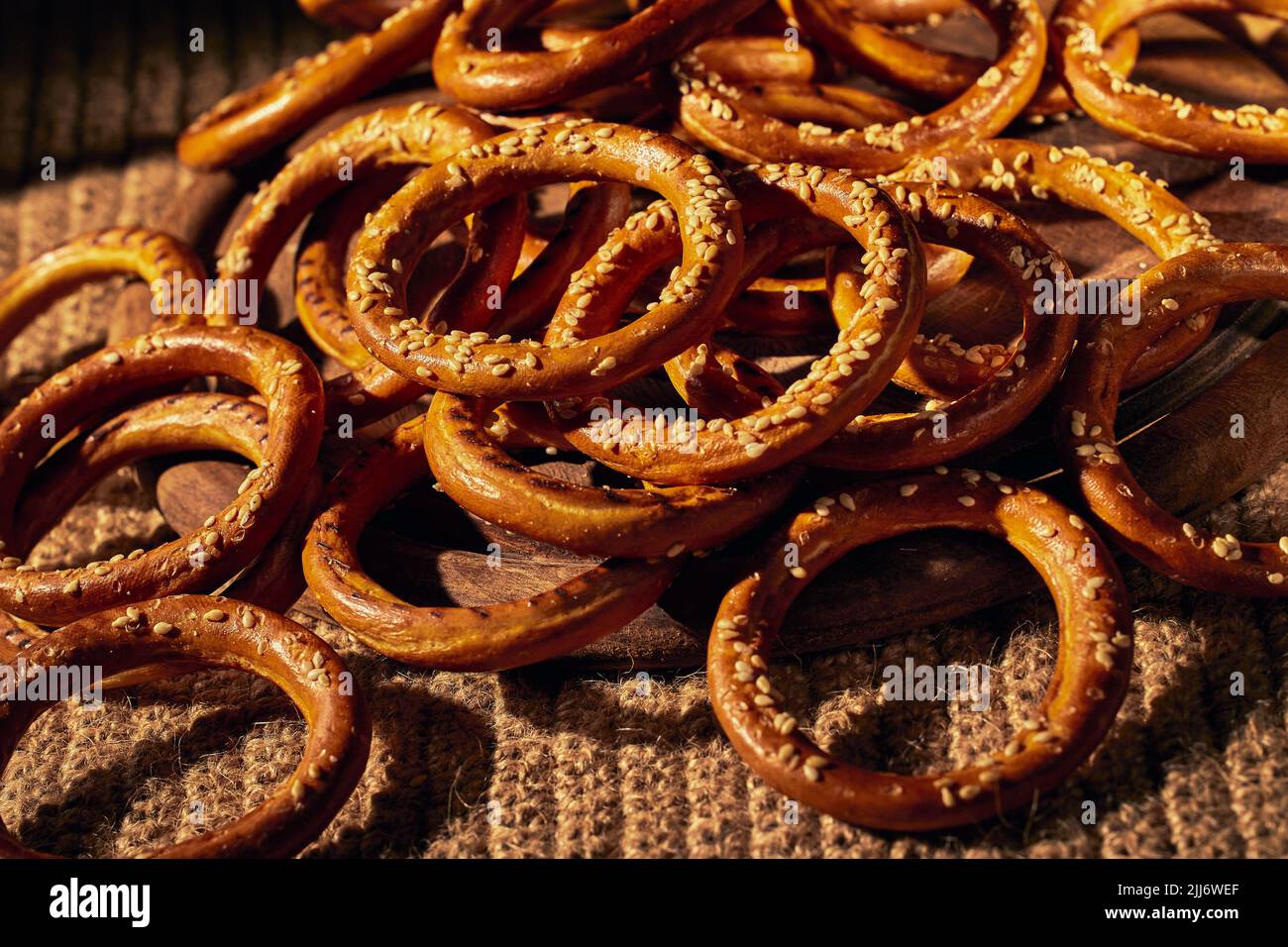 Lots of bagels sprinkled with sesame seeds. Close-up, patern photo. Stock Photo