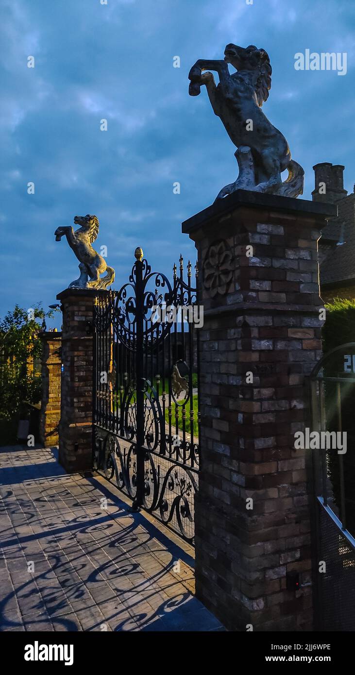A vertical shot of the decorated fences with horse sculptures Stock ...