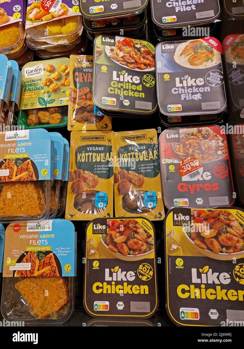 selection of vegan food packages made by different brands in a supermarket Stock Photo