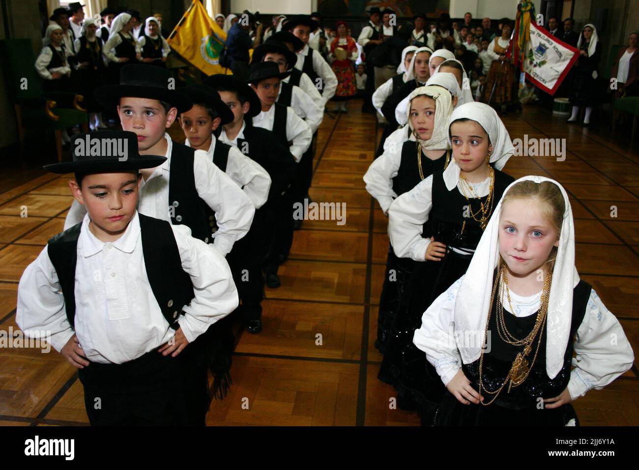 A closeup of kids in traditional clothing dancing traditional dance in the Portuguese parliament Stock Photo