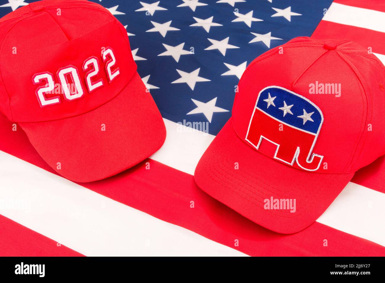 Red MAGA-type cap with 2022 and Republican Elephant & US Stars and Stripes flag. For 2022 US Midterm elections in November & Republican Red Wave. Stock Photo