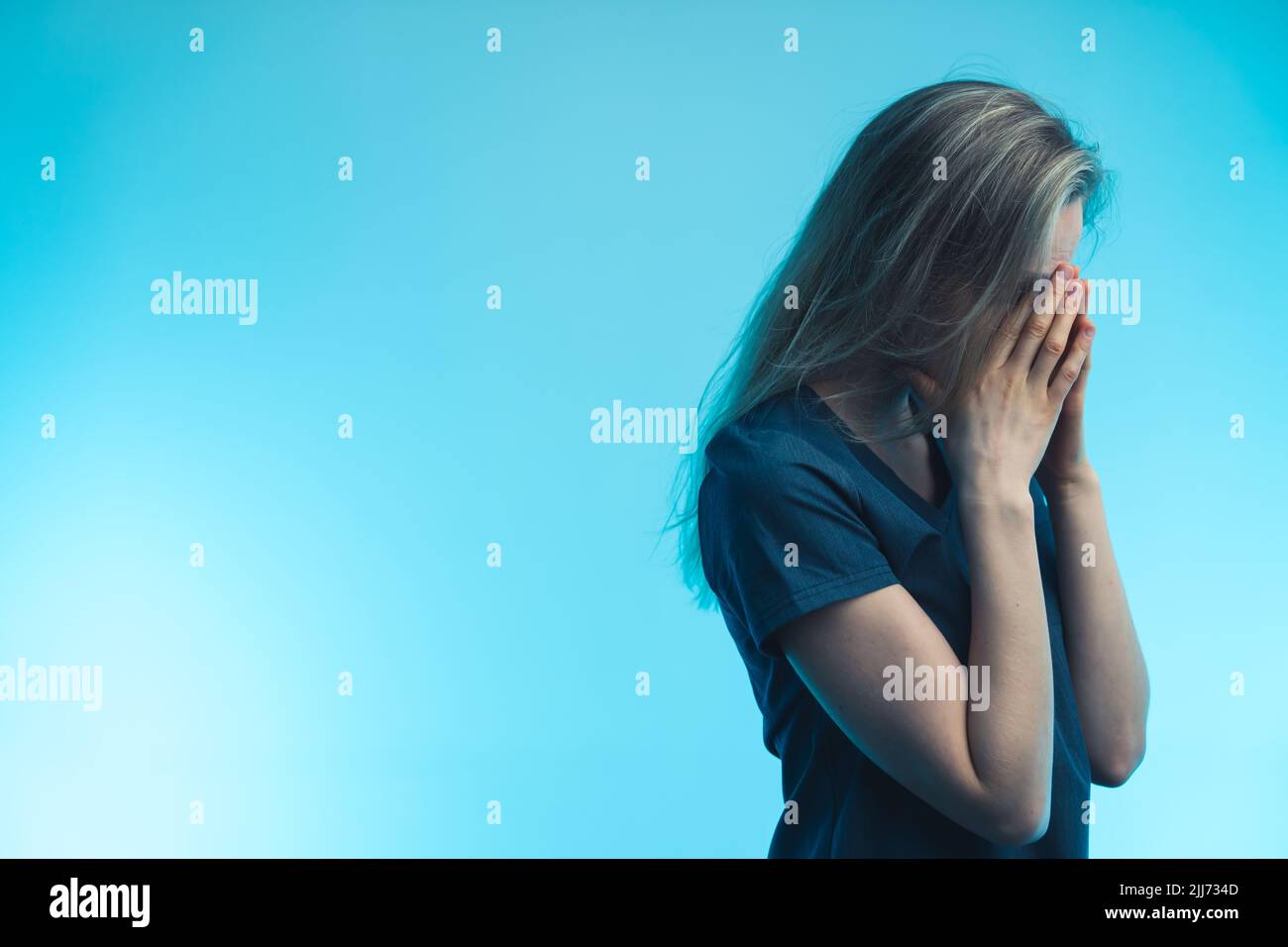 adult female having depression - blue background closeup . High quality photo Stock Photo