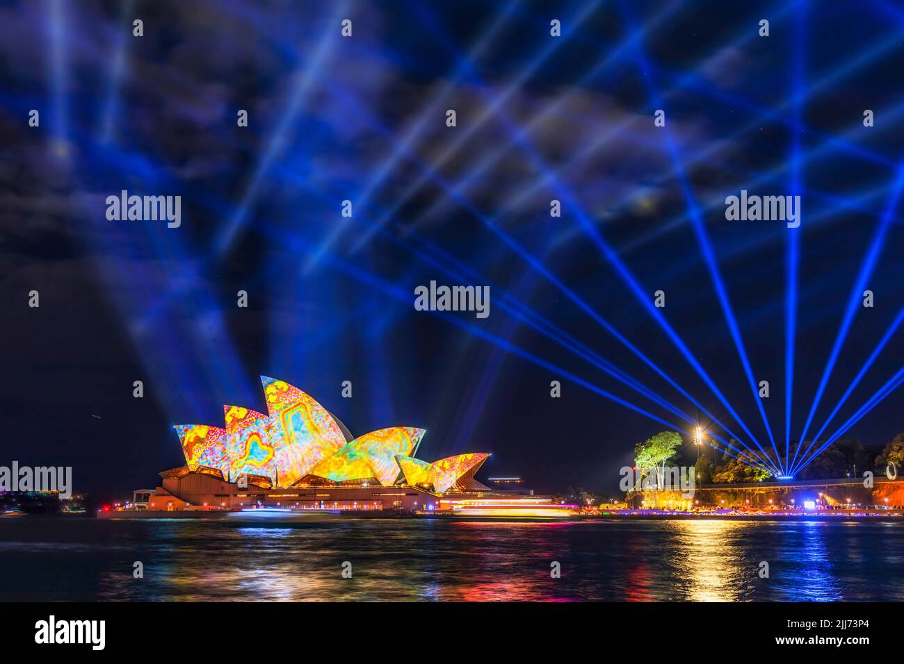 Vivid Sydney lights and ideas laser show over Sydney city CBD Landmards aroud Harbour at night. Stock Photo