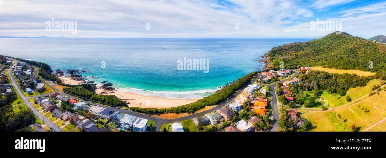 Forster town Burgess beach at hawke cape headland in wide aerial panorama over residential streets to waterfront of Pacific ocean. Stock Photo