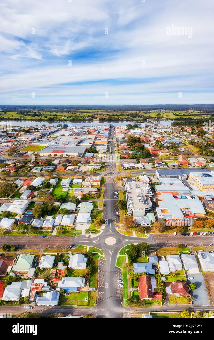 Local residential streets and houses around downtown of Taree - aerial ground to sky vertical panorama. Stock Photo