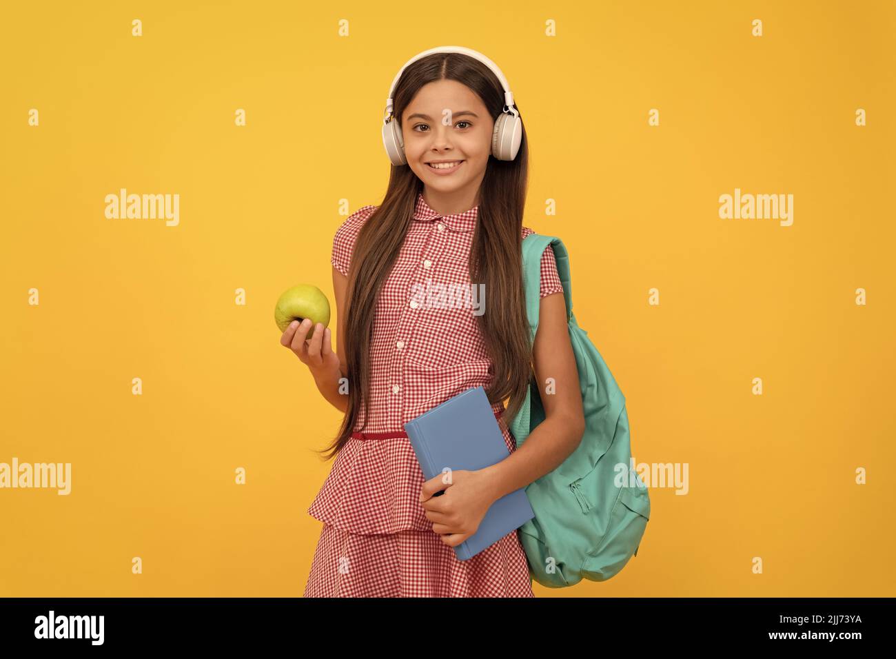 happy school teen girl in headphones carry backpack and workbook with