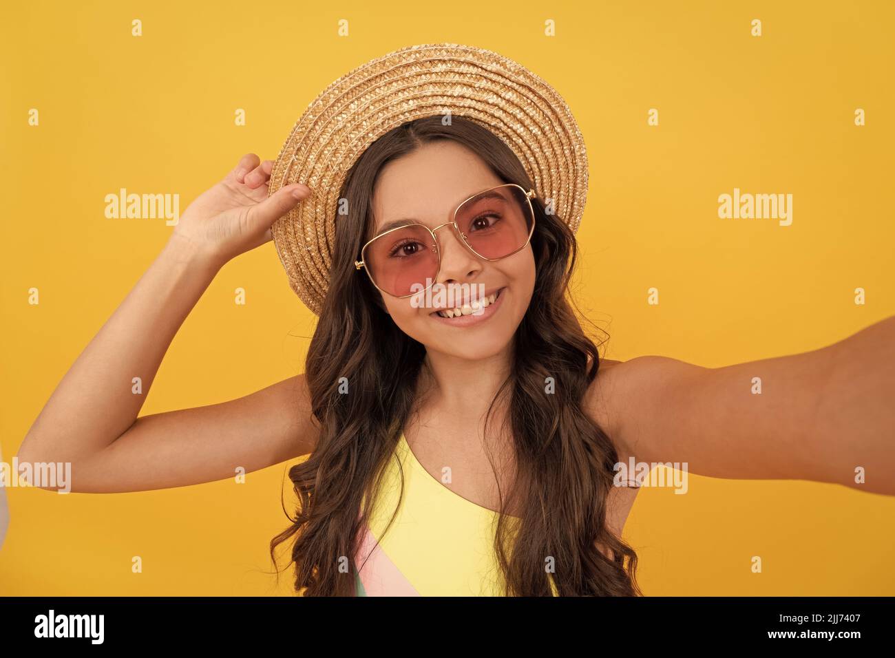selfie time. child wear straw hat and glasses. cheerful teen girl with curly hair Stock Photo