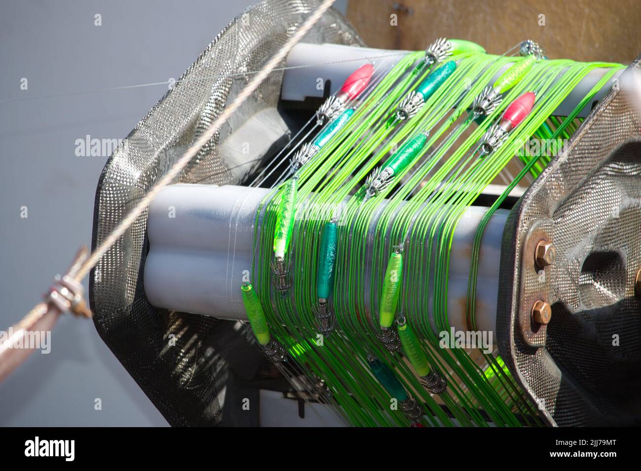 Colourful squid jigs and green fishing line Stock Photo