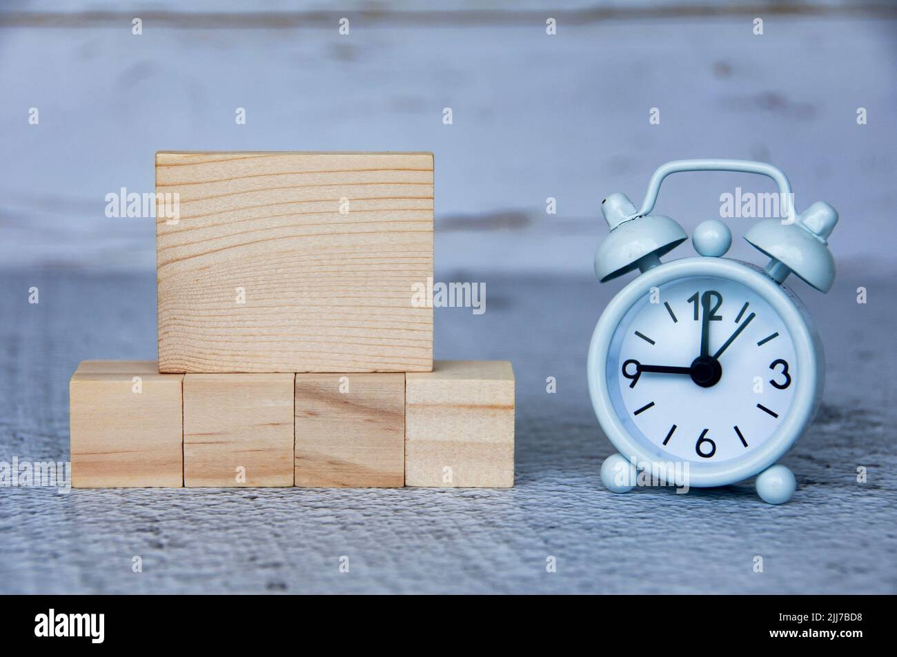 Blank wooden blocks and alarm clock with customizable space for ideas