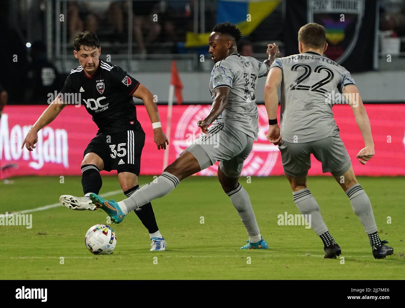 WASHINGTON, DC, USA - 23 JULY 2022: D.C. United midfielder Theodore Ku-DiPietro (35) sends a pass away from CF Montréal defender Keesean Ferdinand (33) during a MLS match between D.C United and C.F. Montreal, on July 23, 2022, at Audi Field, in Washington, DC. (Photo by Tony Quinn-Alamy Live News) Stock Photo