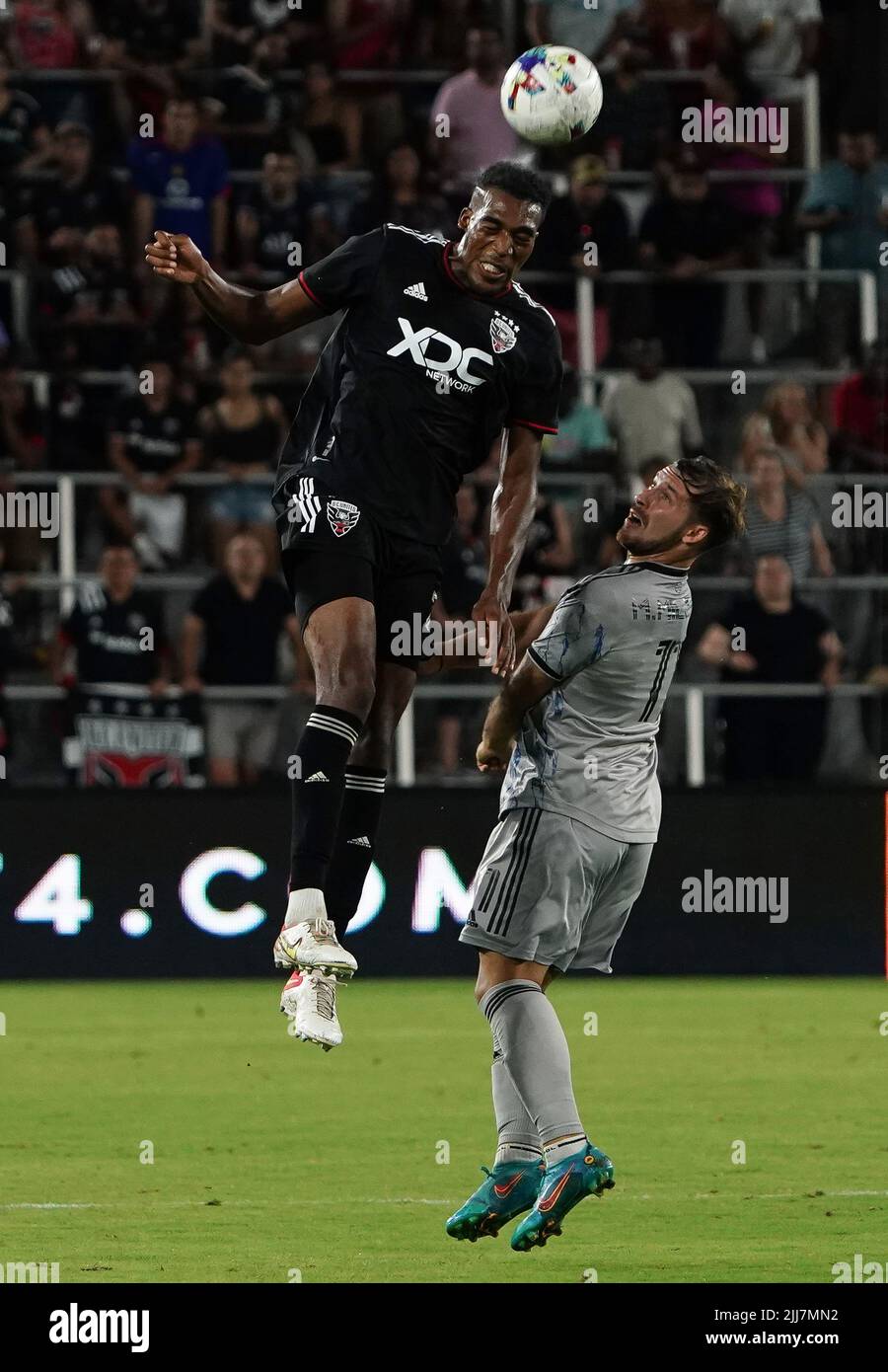 WASHINGTON, DC, USA - 23 JULY 2022: D.C. United defender Donovan Pines (23) heads over CF Montréal midfielder Matko Miljevic (11) during a MLS match between D.C United and C.F. Montreal, on July 23, 2022, at Audi Field, in Washington, DC. (Photo by Tony Quinn-Alamy Live News) Stock Photo