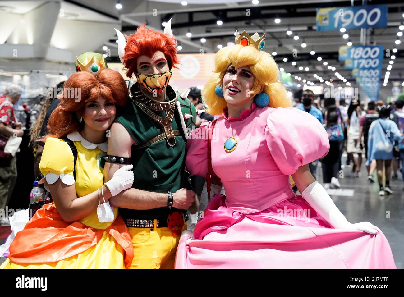 Karamia Capri (L), Alec Crow, and Jimmy Sherfy cosplay as Princess Daisy,  Bowser, and Princess Peach from the Mario video games at Comic-Con  International in San Diego, California, U.S., July 23, 2022.
