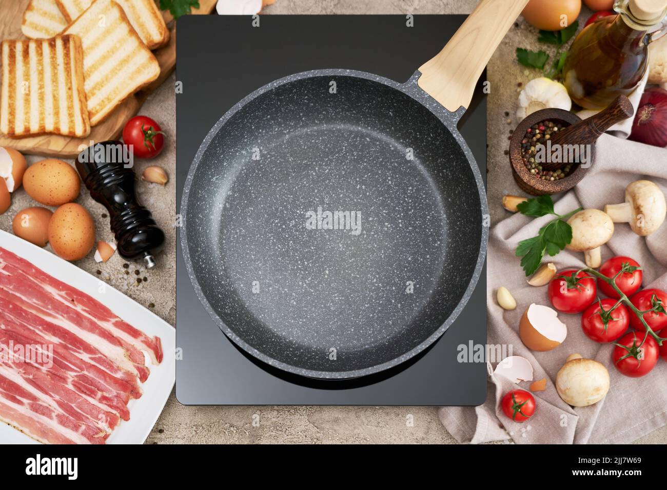 Making fried eggs and bacon frying pan on induction hob and