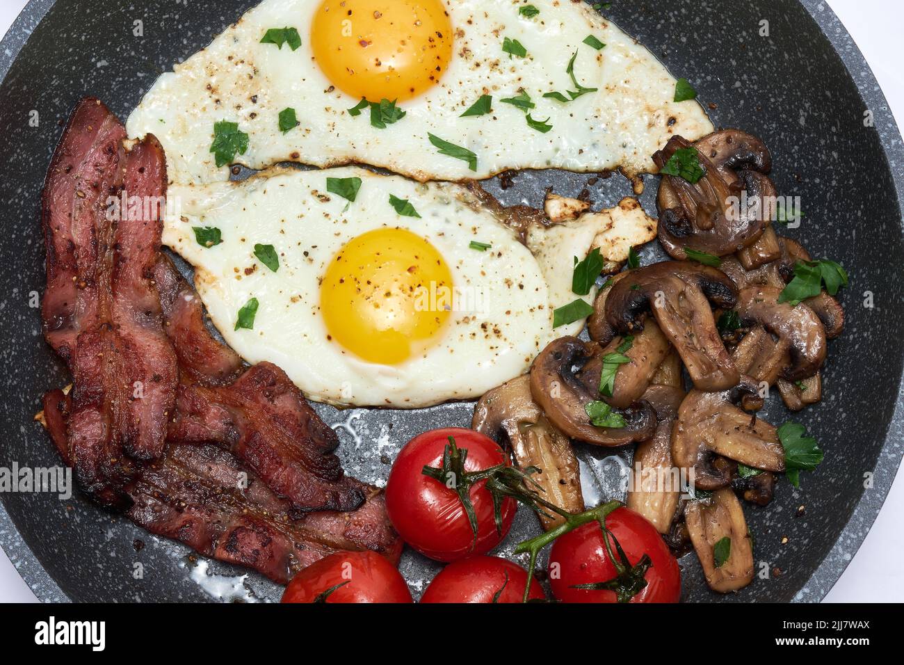 Fried eggs and bacon on a frying pan isolated on white background Stock ...