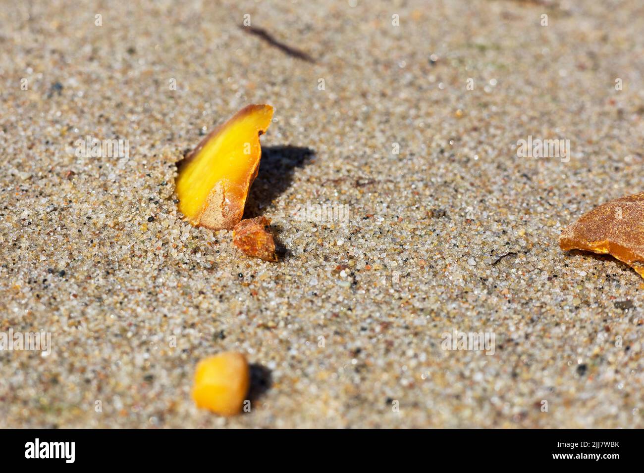 Amber on fine sand, beautiful piece of amber from the sand Stock Photo