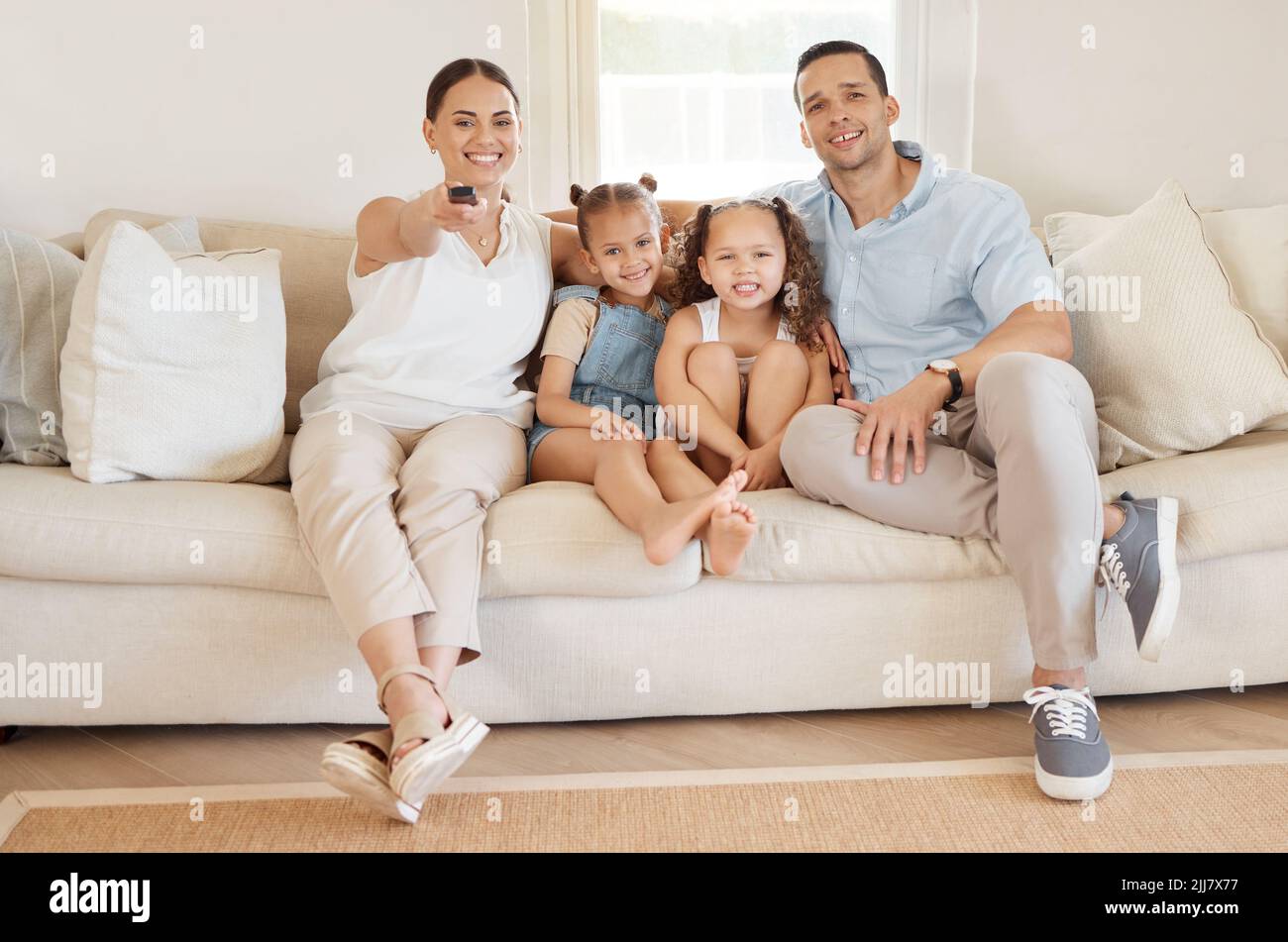 Its family movie time. a woman using a tv remote while watching