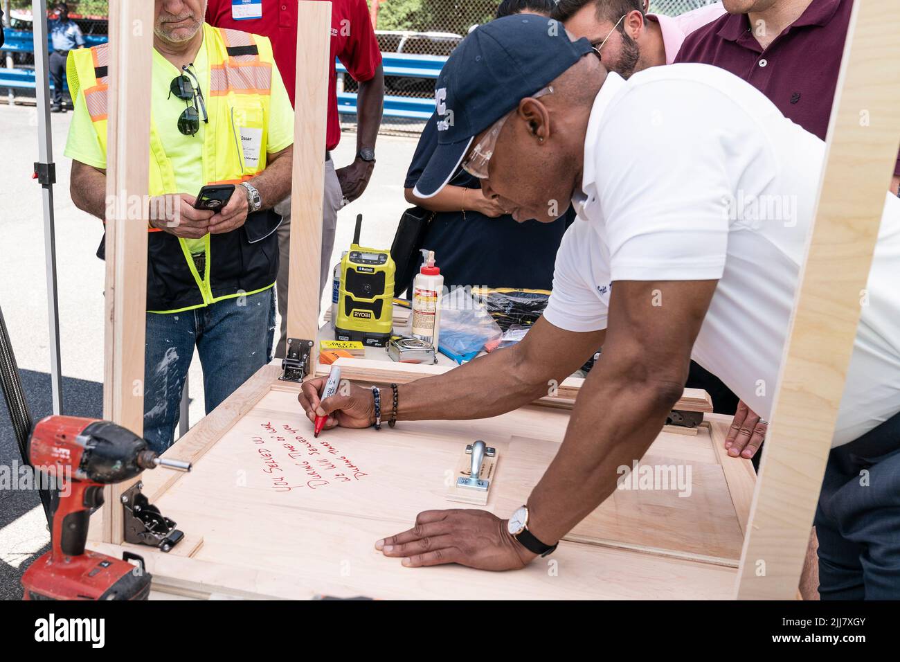 New York, USA. 23rd July, 2022. Mayor Eric Adams signed foldable table during DVS Furniture Build-a-Thon at JFK High School campus in New York on July 23, 2022. Furniture Build-a-Thon was organized by Fuller Center by volunteers to make foldable tables and stools for formerly homeless veterans who have recently moved into their new homes. (Photo by Lev Radin/Sipa USA) Credit: Sipa USA/Alamy Live News Stock Photo