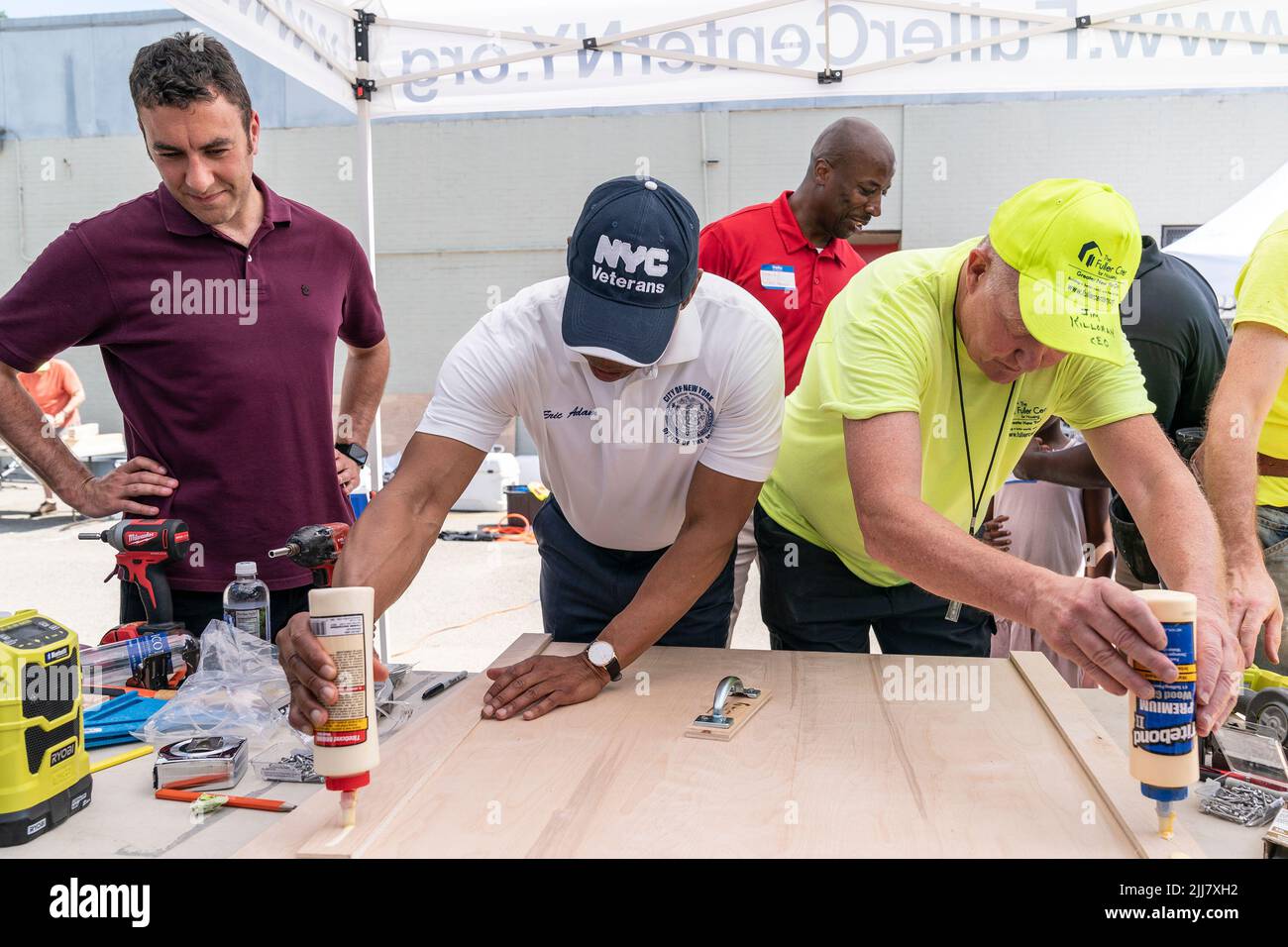 New York, USA. 23rd July, 2022. Mayor Eric Adams joined volunteers during DVS Furniture Build-a-Thon at JFK High School campus in New York on July 23, 2022. Furniture Build-a-Thon was organized by Fuller Center by volunteers to make foldable tables and stools for formerly homeless veterans who have recently moved into their new homes. (Photo by Lev Radin/Sipa USA) Credit: Sipa USA/Alamy Live News Stock Photo