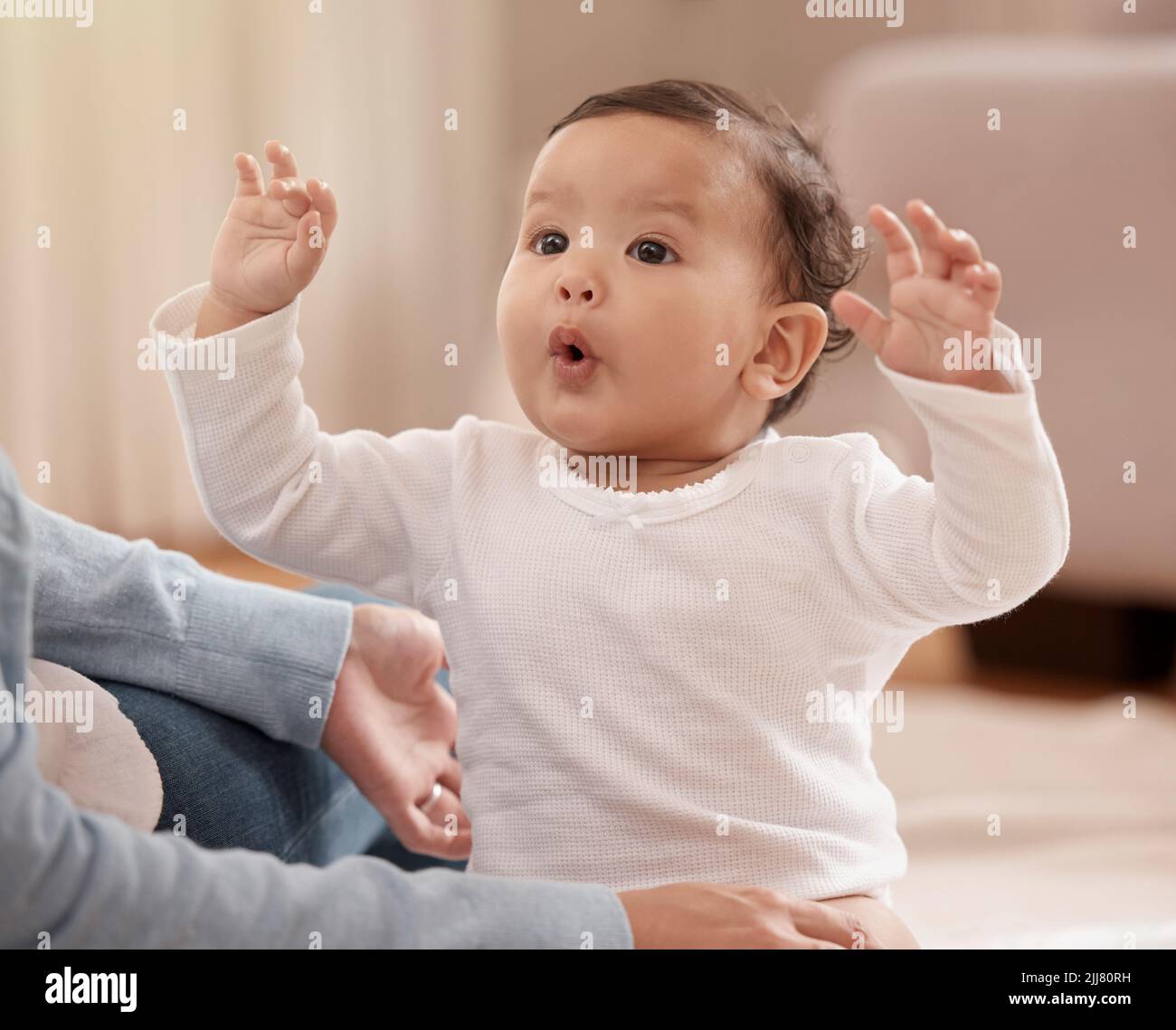 The beginning of a wonderfully big personality. an adorable baby girl sharing a playful moment with her mother at home. Stock Photo