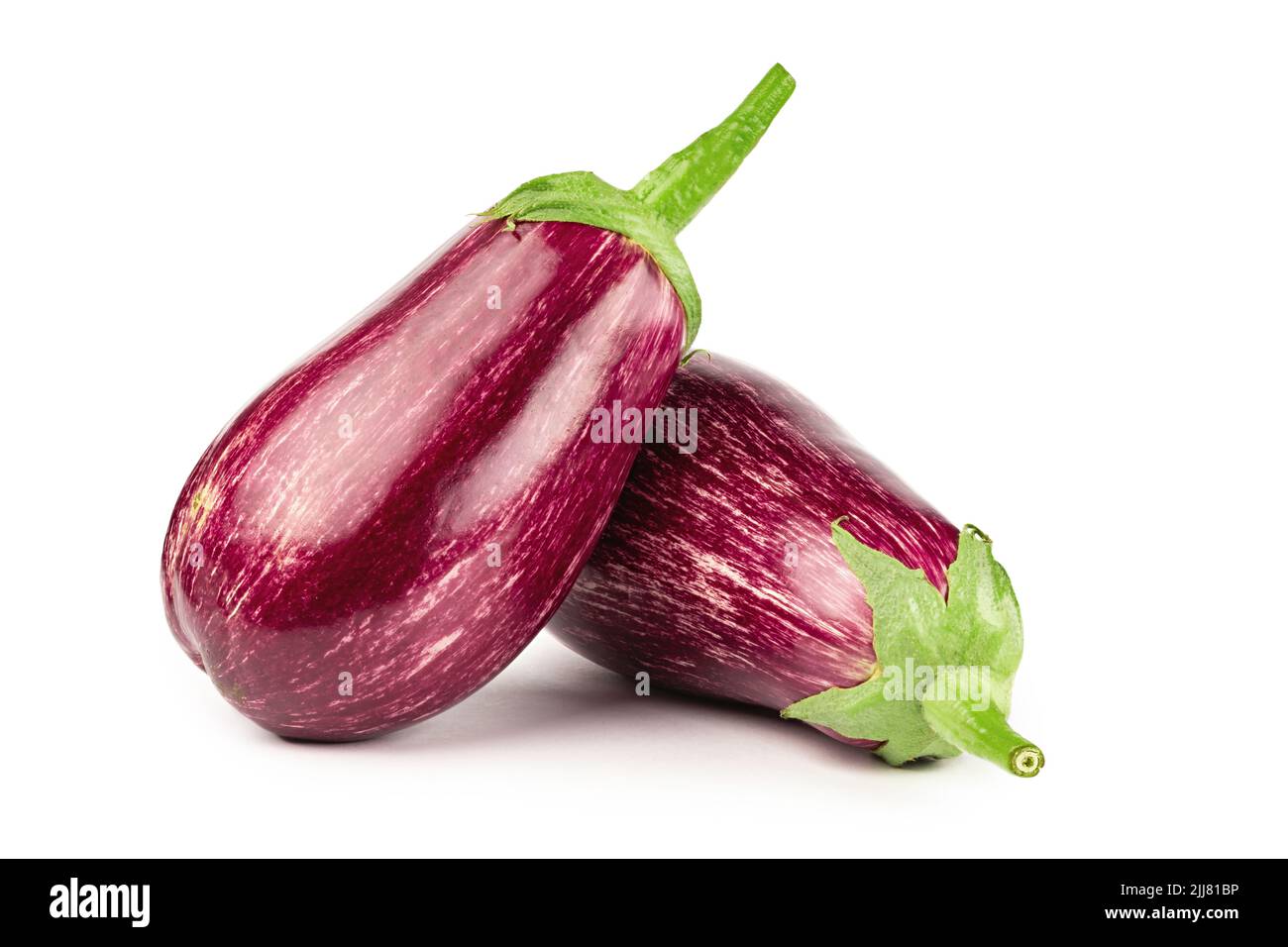 Purple eggplants. Fresh striped aubergines and eggplants with leaf