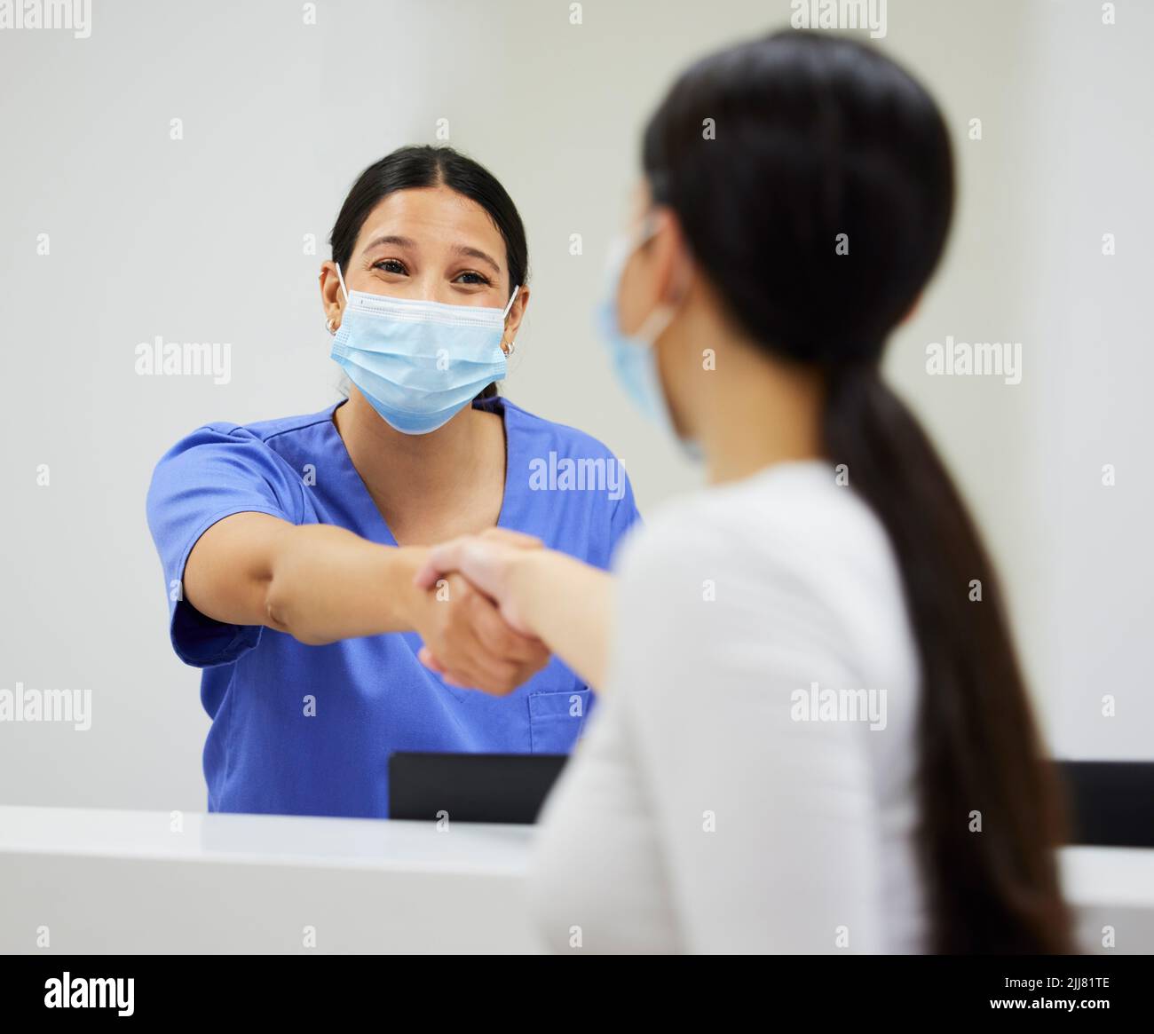 Hvae a nice day. a nurse and patient shaking hands in a clinic. Stock Photo