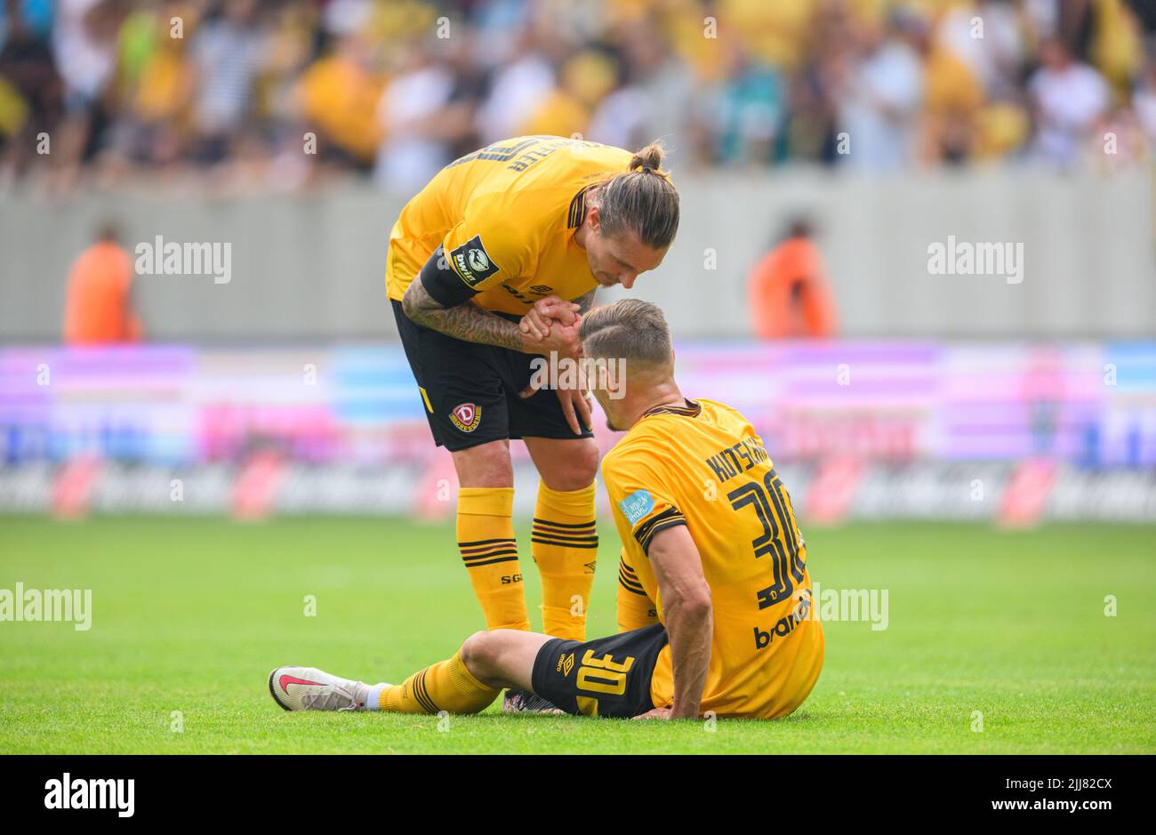 Dresden, Germany. 23rd July, 2022. Soccer: 3rd league, SG Dynamo Dresden - TSV  1860 Munich, Matchday 1, Rudolf Harbig Stadium. Dynamo's Kevin Ehlers  (l-r), Tim Knipping and Dennis Borkowski emotional. Credit: Robert