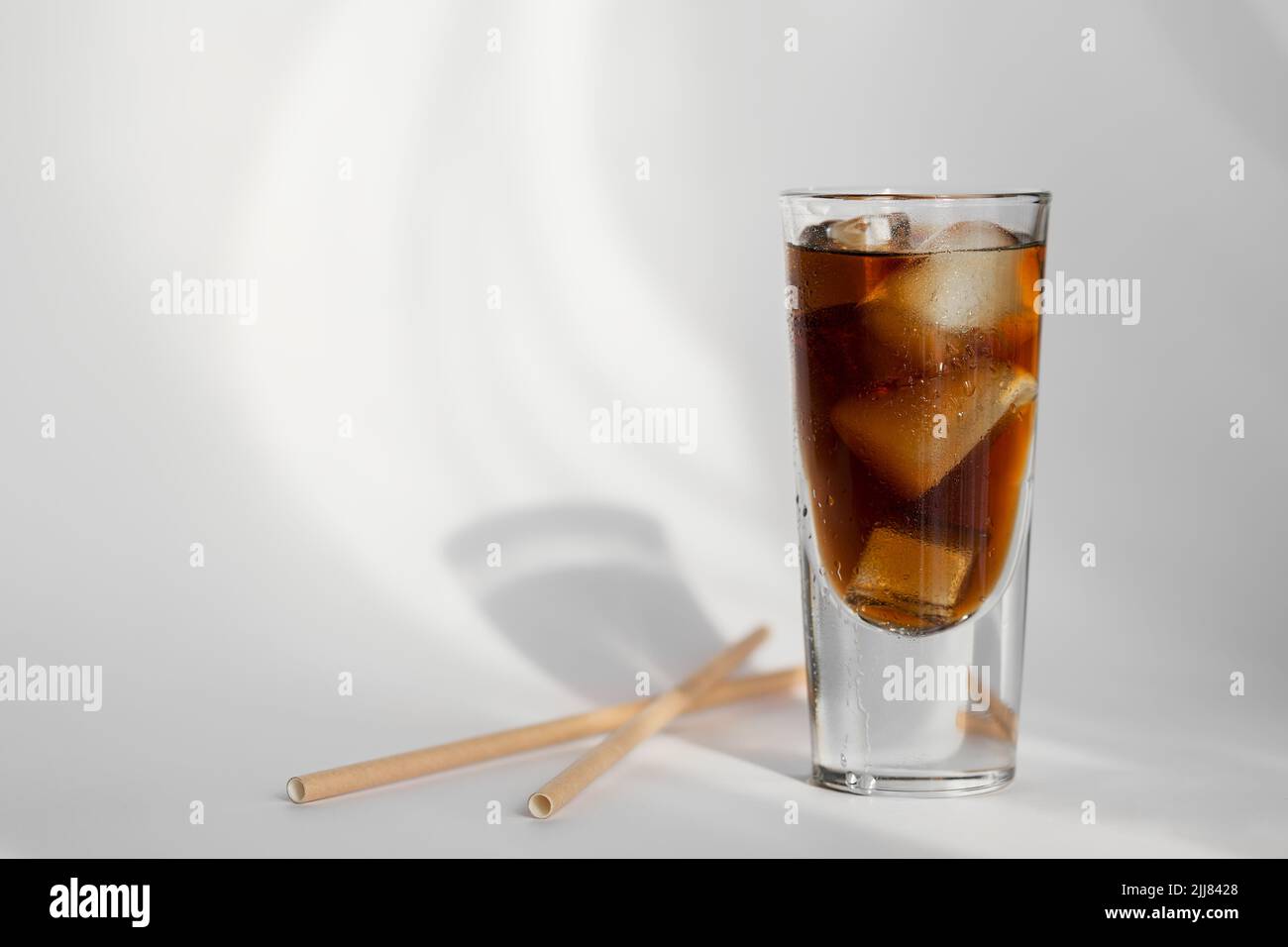 Glass of cola with ice and straw on a white background Stock Photo - Alamy