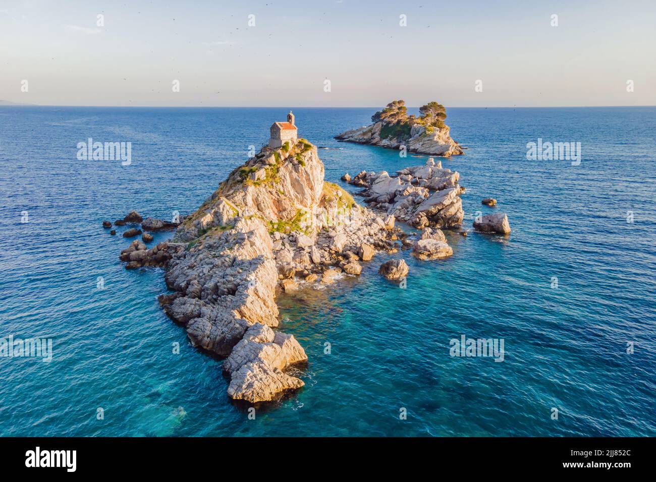 Sveta Nedelja is an islet on the Adriatic Sea, in Montenegrin municipality  of Budva. It is located opposite the town of Petrovac na Moru in Montenegro  Stock Photo - Alamy