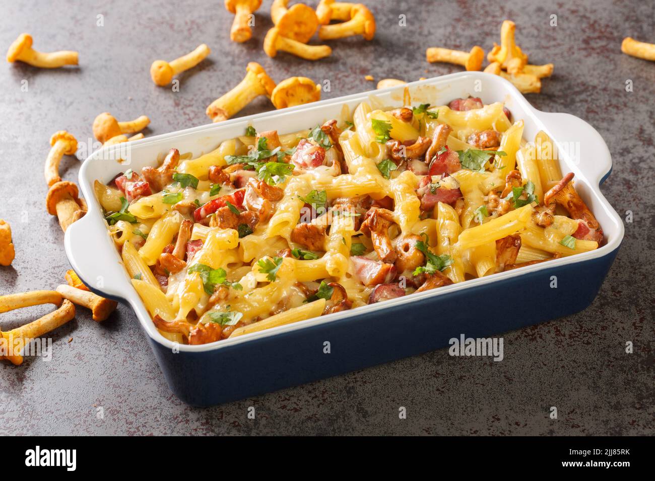 Homemade casserole with pasta, mushrooms, bacon and cheese served hot