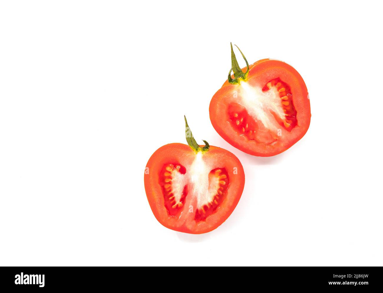 Isolated cut-half of red tomato on white background, fresh two half-cut tomatoes. Stock Photo