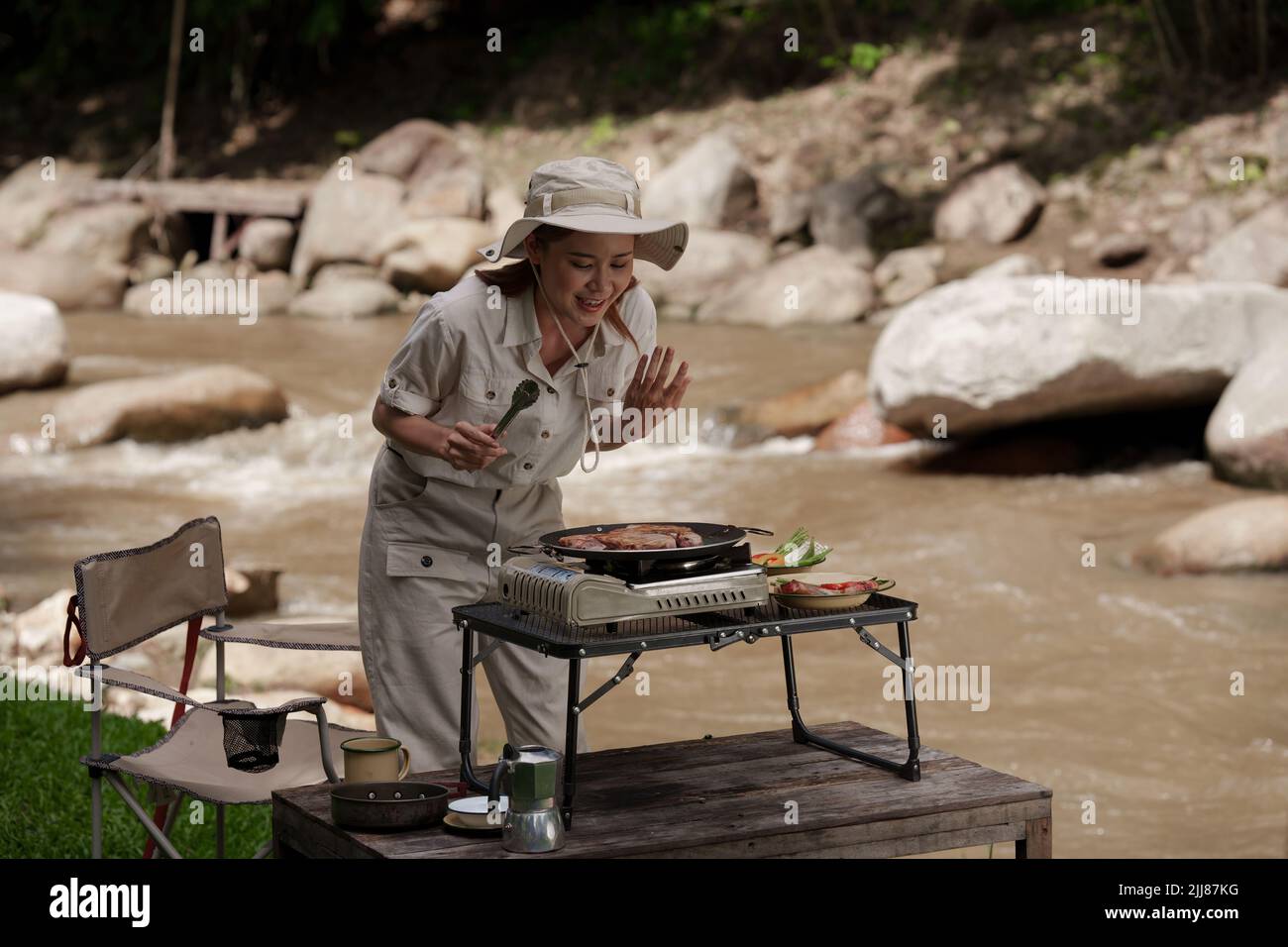 Asian woman journey and camping and making grill food. Travel outdoor