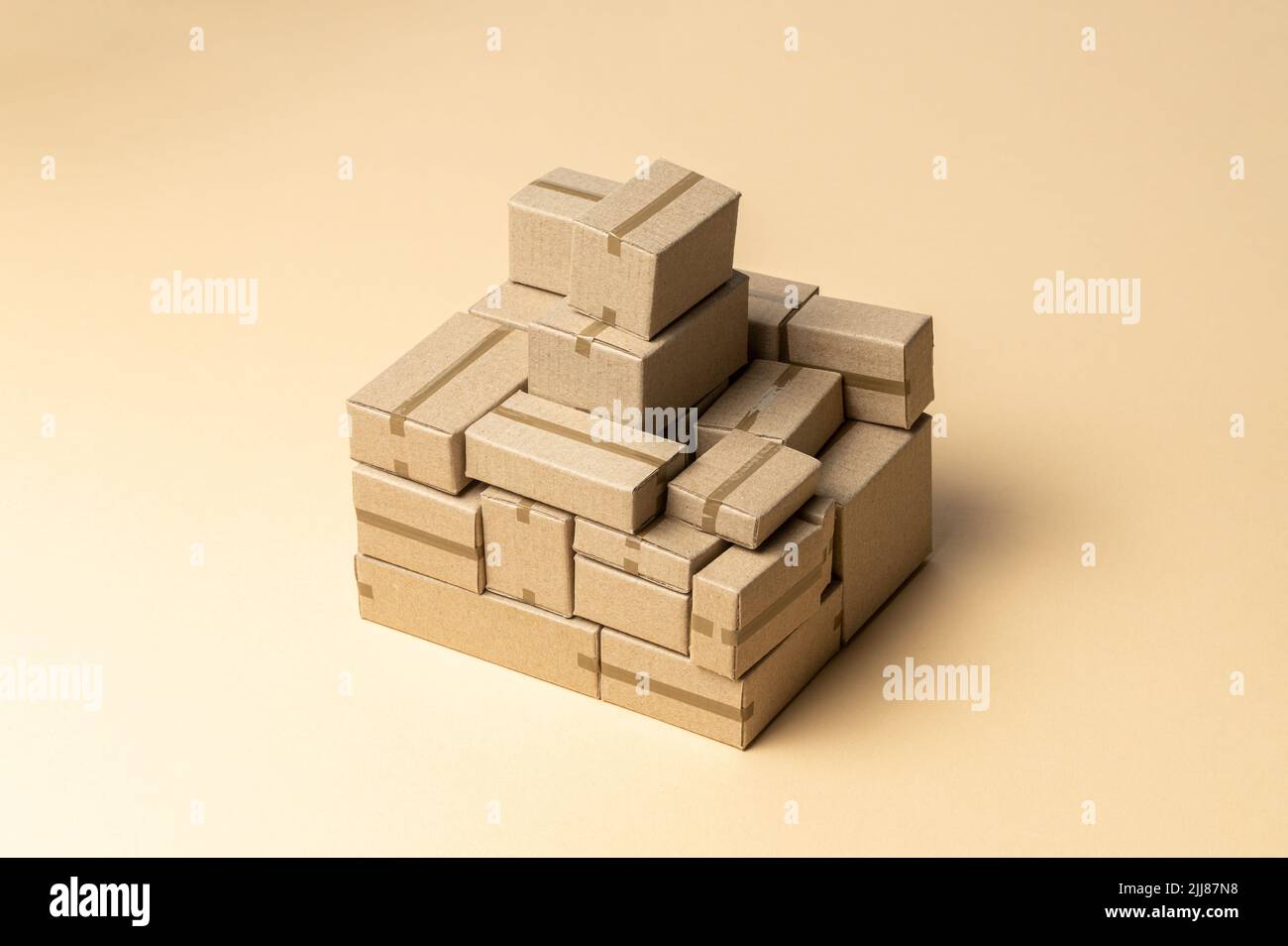 Heap cardboard boxes on a brown background. Stock Photo