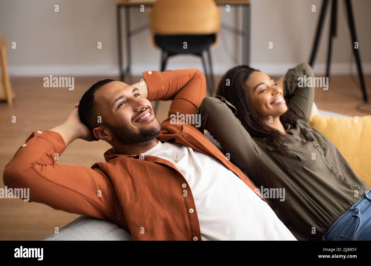 Relaxed Black Couple Sitting On Couch Relaxing Together At Home Stock ...