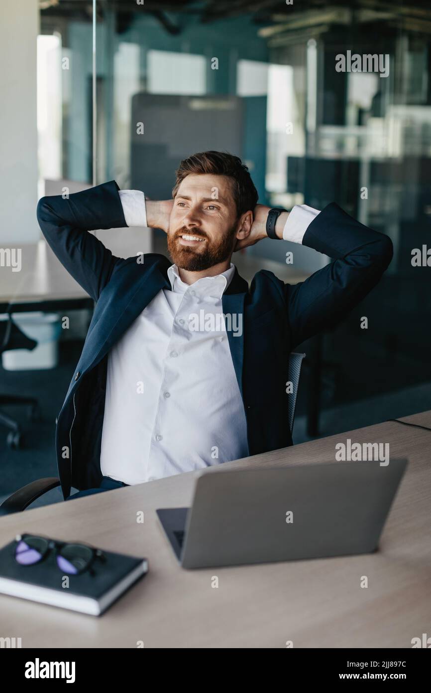 Taking break from work. Excited businessman relaxing on chair, leaning