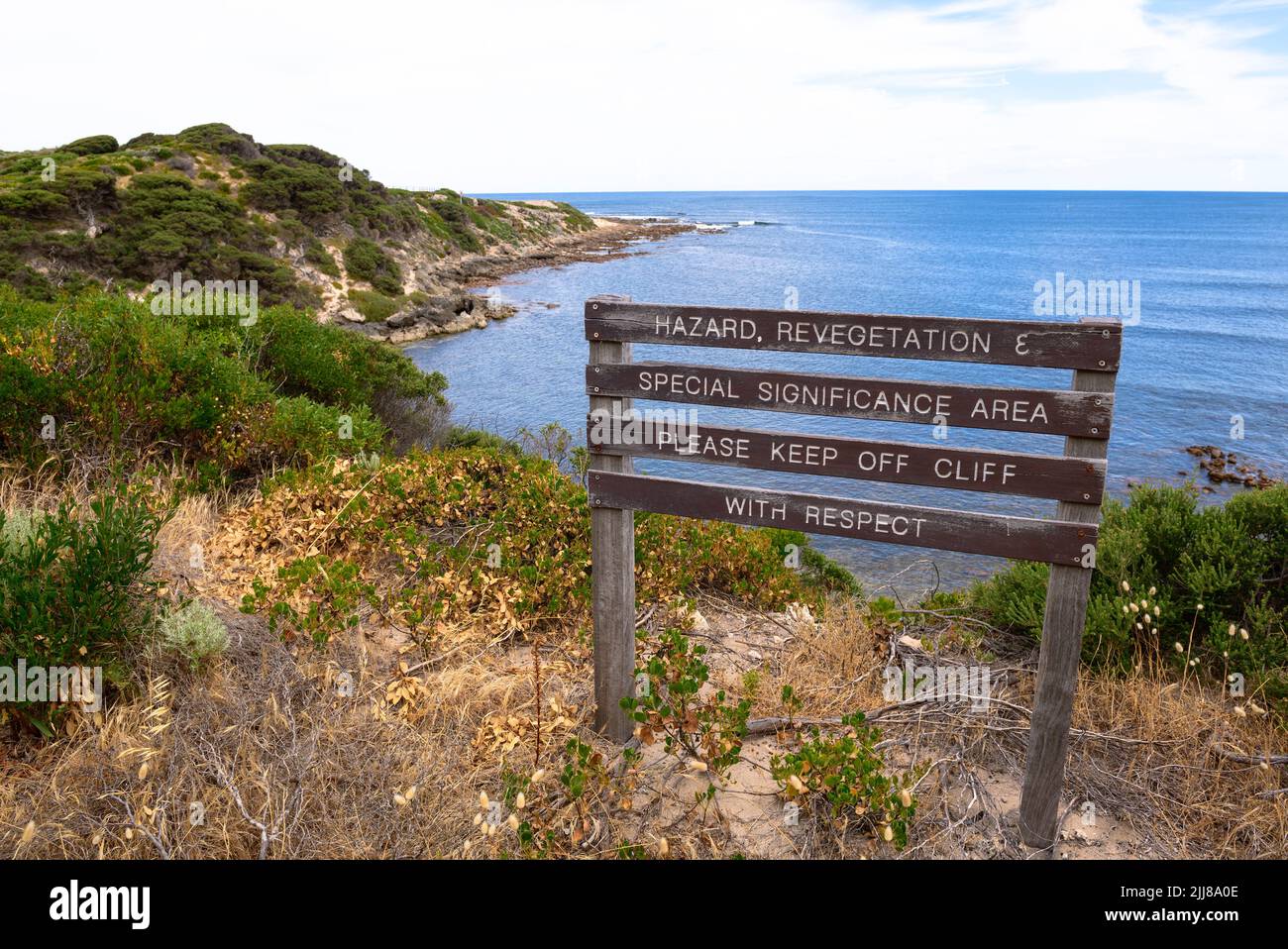 Sign warning of danger and asking for respect, on the cliffs above the site of the 1996 Gracetown Tragedy, Cowaramup Bay, Gracetown, Western Australia Stock Photo