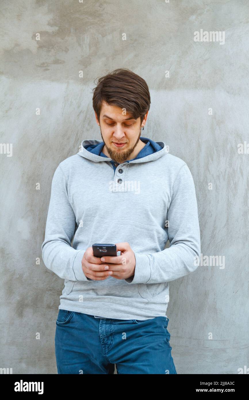 Young man writing sms Stock Photo